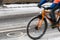 A snow-capped bike path and a partial view of a cyclist