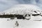 Snow capped Galvarina Plateau; on backgrounf Galvarina Refuge and Etna Mount under lenticular cloud,