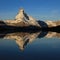 Snow capped Mount Matterhorn reflecting in Lake Stellisee