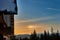 Snow-capped mountain huts, sunset over winter mountains