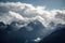 snow-capped mountain range, with clouds gathering in the distance