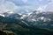 Snow Capped Mountains Above the Tree Line in a Pine Tree Forest