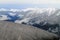 Snow-capped Mountains Beyond Snow Covered Hills