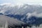 Snow-capped Mountains Beyond Snow Covered Hills