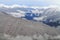 Snow-capped Mountains Beyond Snow Covered Hills