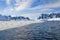 Snow capped mountains and broken ice in the waters of Antarctica
