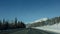 Snow-capped mountains with coniferous forest along Trans-Canada Highway in Banff National Park