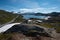 Snow capped mountains and crystal clear lakes along the Sognefjellsvegen, highest mountain road of Northern Europe