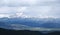 Snow Capped Mountains Shrouded in Storm Clouds