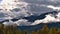 Snow-capped Rocky Mountains in autumn with yellow colored deciduous trees in front near McBride in Robson Valley, BC, Canada.