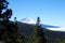 Snow capped volcano with pine forrest