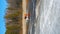 Snow Clad Trail Conqueror. Red ATV Arctic Odyssey. Vertical 9x16 Aerial Drone shot