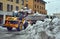 Snow cleaning tractor snow-removal machine loading pile of snow on a dump truck