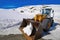 Snow clearing excavator in Aran Valley