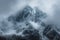 Snow cloaked mountain stands tall beneath a moody, overcast sky