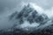 Snow cloaked mountain stands tall beneath a moody, overcast sky