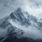 Snow cloaked mountain stands tall beneath a moody, overcast sky