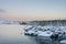 Snow cover mountain peak, coast, and cod fish wooden rack in Lofoten Islands Norway