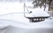 A snow covered barbecue on a patio deck