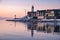 snow covered beach during wnter by Urk lighthouse in the Netherlands