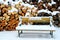 Snow Covered Bench by Woodpile