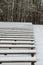 snow covered benches in park in winter