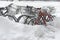 Snow covered bicycles on street after winter snowstorm