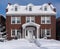 Snow covered brick house