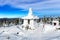 Snow-covered Buddhist stupa on mountaintop