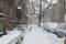 Snow covered cars on street after winter snowstorm