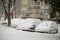 Snow covered cars stuck at parking