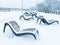 Snow-covered chaise-longues in a park in Moscow