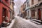 snow-covered cobblestone street in a quaint town