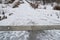 Snow-covered concrete staircase in an old city park. Dangerous descent down