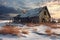 snow-covered dilapidated barn in a winter landscape