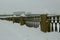 Snow-covered fences on the city embankment