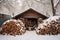 snow-covered firewood pile outdoors