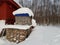 Snow covered firewood stacks outside in the cold arctic circle wintertime