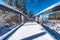 Snow covered footbridge, blue sky morning