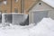 Snow-covered gate and trick. snow sweeps. The concept of a snowy winter. Snow blocked the entrance. Snow-covered iron gates.