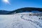 Snow covered glade and tourist winter hiking trail