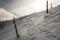 Snow covered green and red marked hiking trail bellow Barania Gora hill in winter Beskid Slaski mountains in Poland