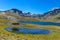 Snow covered high mountain and blue lakes in Andes