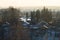 Snow covered houses with the gardens in winter. wooden houses in the forest aerial view. rural landscape