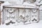 Snow-covered iron gates. winter wrought fence gates