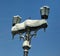 Snow covered lamppost on background of clear sky and wires