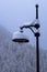 Snow covered lamppost in snow storm turning landscape snowy