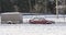 Snow-covered long-standing meadow car with trailer  in winter on the street