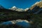 Snow covered Mount cook in New zealand mirroring in tiny lake