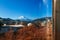 Snow covered Mount Fuji and local town along train route seen through window in Shimoyoshida - Fujiyoshida, Japan